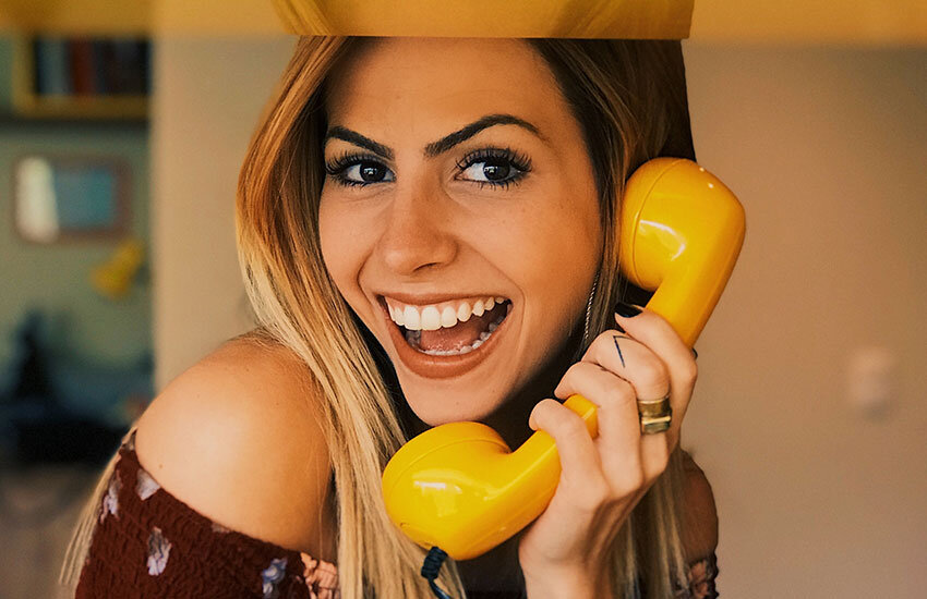 woman hold yellow phone is  a happy customer